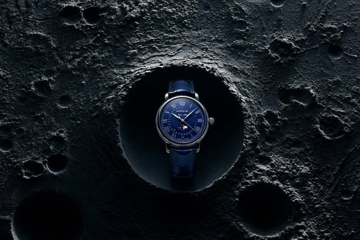 The Montblanc Star Legacy Full Calendar watch showcases its midnight blue dial against a textured moon surface backdrop, highlighting the lunar phase complication and exquisite craftsmanship. #MontblancStarLegacy #LuxuryWatches #ElegantTimepieces