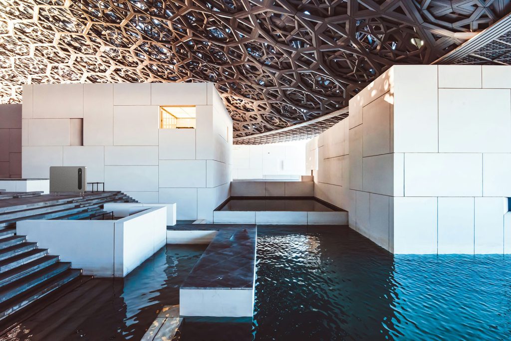 Architectural interior with water features and geometric roof detail, featuring a Solenco dehumidifier that demonstrates advanced humidity control in coastal and high-moisture spaces.